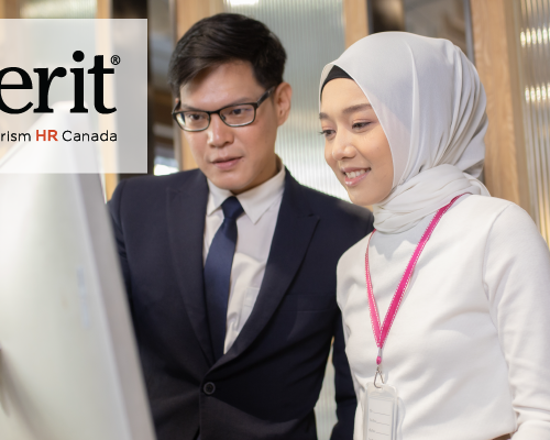 The image features two professionals working together while looking at a large screen. One person is wearing a suit and glasses, and the other is wearing a light-colored hijab with a pink lanyard. In the upper left corner, there is a logo for "emerit" by Tourism HR Canada. The setting appears to be an office environment.