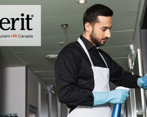 The image shows a worker wearing a black shirt, white apron, and blue gloves, cleaning a surface with a spray bottle in a professional environment. The person appears focused on their task. In the upper left corner, the logo for "emerit" by Tourism HR Canada is displayed, suggesting a connection to training or certification in the tourism or hospitality sector.